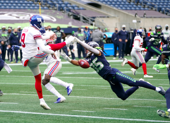 The kick is being blocked and the defender is close to the kicker's foot/leg The kick is being blocked and the defender is close to the kicker's foot/leg