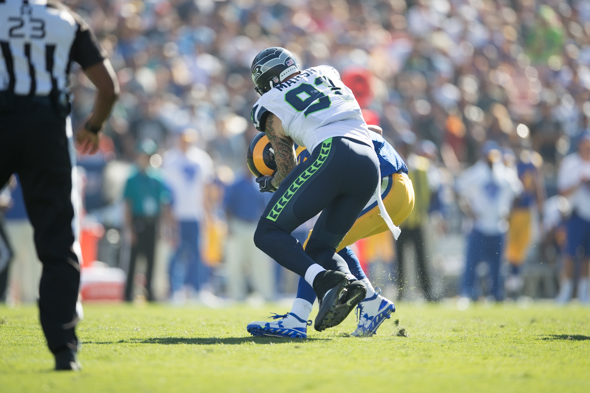 Player grabbing the face mask of an opposing player Player grabbing the face mask of an opposing player