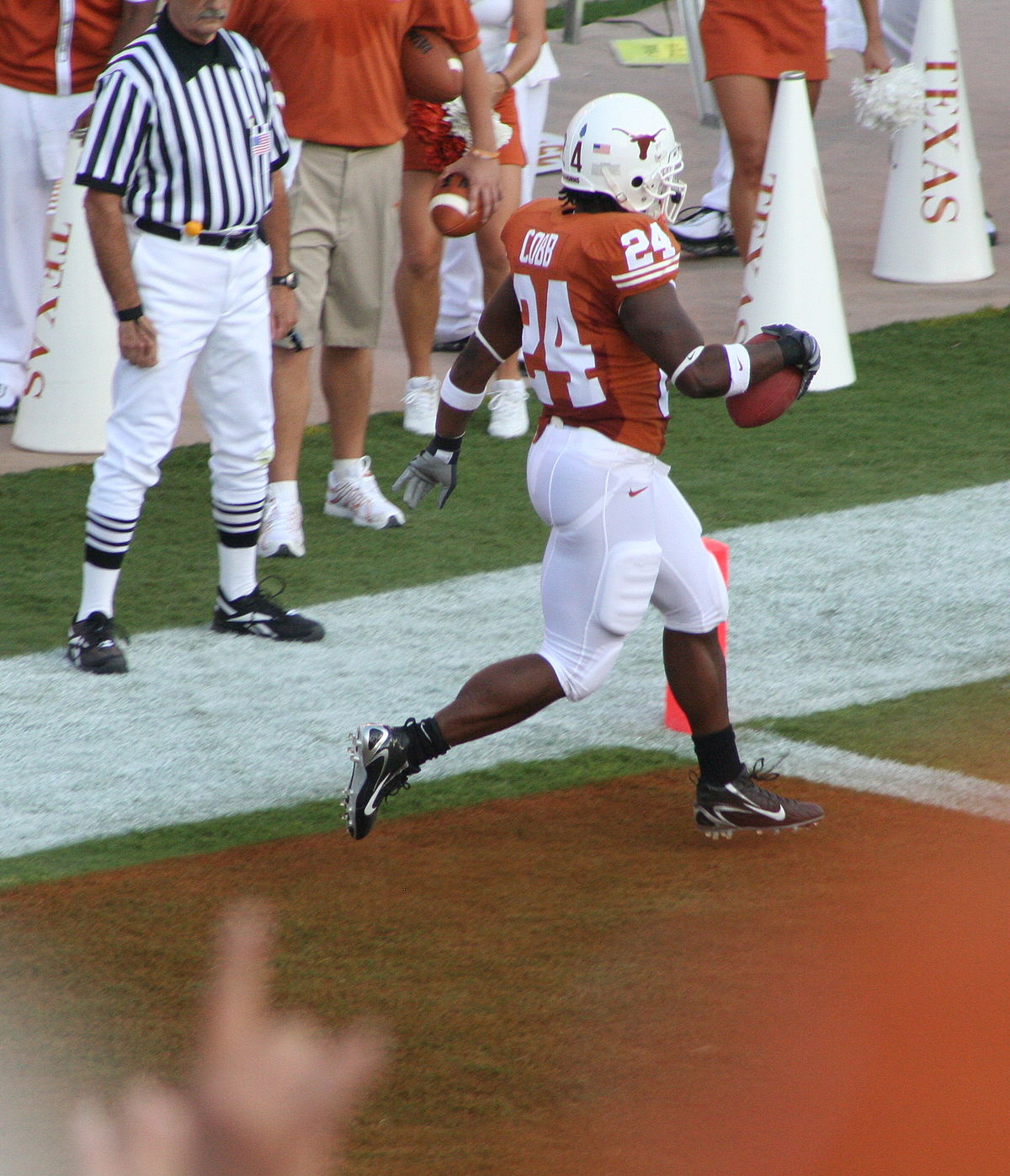 A runner crosses the goal line to score a touchdown A runner crosses the goal line to score a touchdown